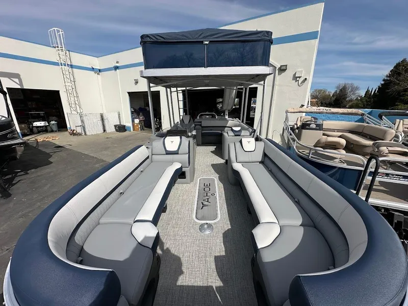 Slide: The Image of 2025 Tahoe Pontoon Cascade Cruise Funship with spacious seating at a marina. - 11