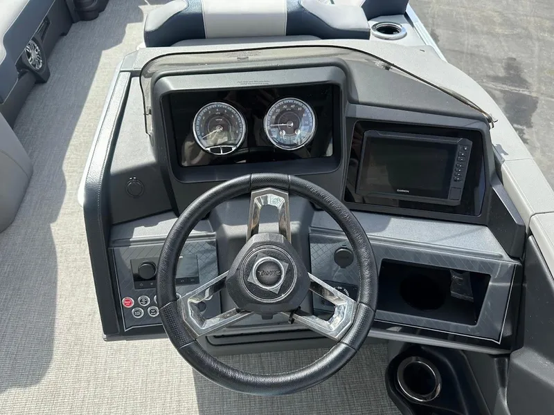 Slide: The Image of 2025 Tahoe Pontoon Cascade Cruise Funship dashboard with steering wheel and gauges. - 27