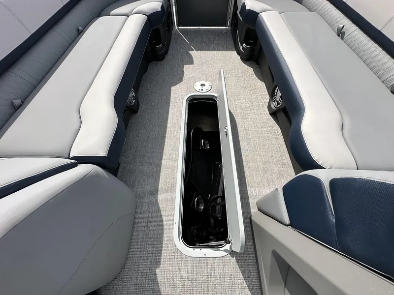 Slide: The Image of 2025 Tahoe Pontoon Cascade Cruise Funship interior with open storage compartment. - 30