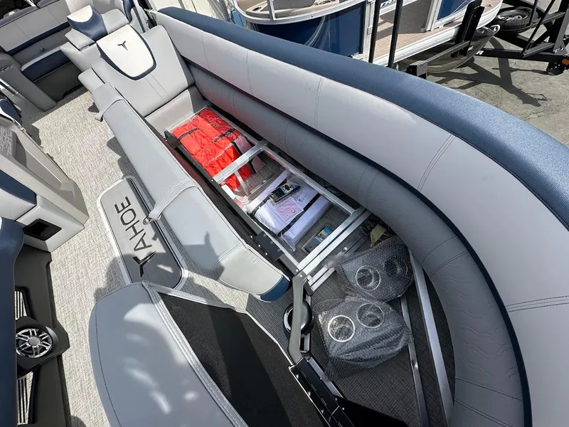 Slide: The Image of 2025 Tahoe Pontoon Cascade Cruise Funship interior with storage compartment and life jackets. - 32