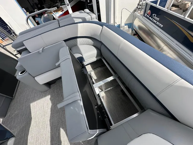 Slide: The Image of 2025 Tahoe Pontoon Cascade Cruise Funship interior seating with storage compartment open. - 33