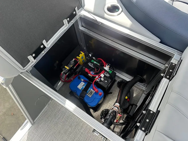 Slide: The Image of 2025 Tahoe Pontoon Cascade Cruise Funship battery compartment with wiring and components. - 36