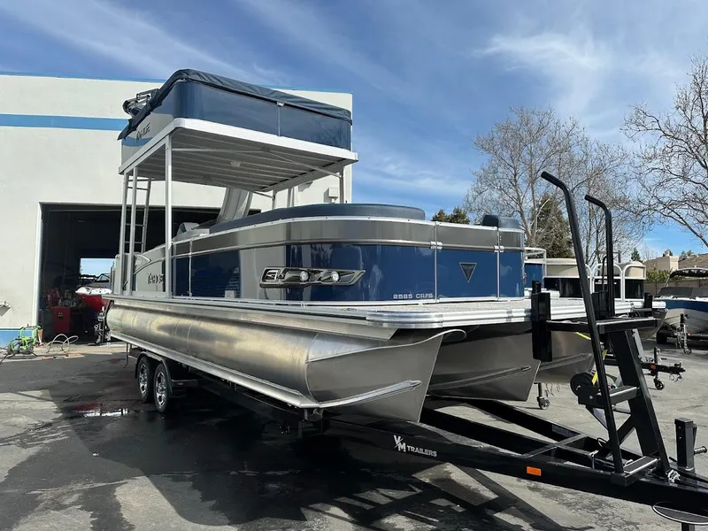 Slide: The Image of 2025 Tahoe Pontoon Cascade Cruise Funship on trailer, parked outdoors. - 5