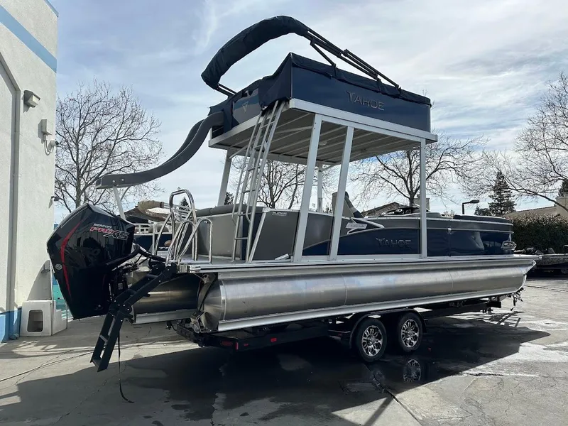 Slide: The Image of 2025 Tahoe Pontoon Cascade Cruise Funship with slide, parked on a trailer outdoors. - 7
