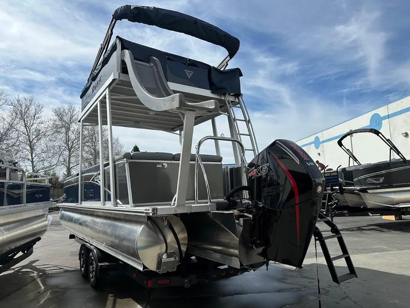 Slide: The Image of 2025 Tahoe Pontoon Cascade Cruise Funship with outboard motor, docked under a clear sky. - 9