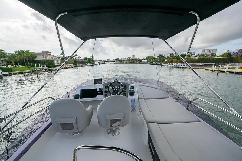Slide: The Image of 2017 Beneteau Gran Turismo 49 Flybridge, luxurious helm view on calm waters. - 17