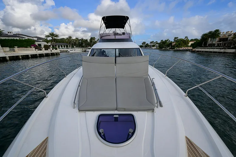Slide: The Image of 2017 Beneteau Gran Turismo 49 Fly yacht on a scenic waterway. - 2