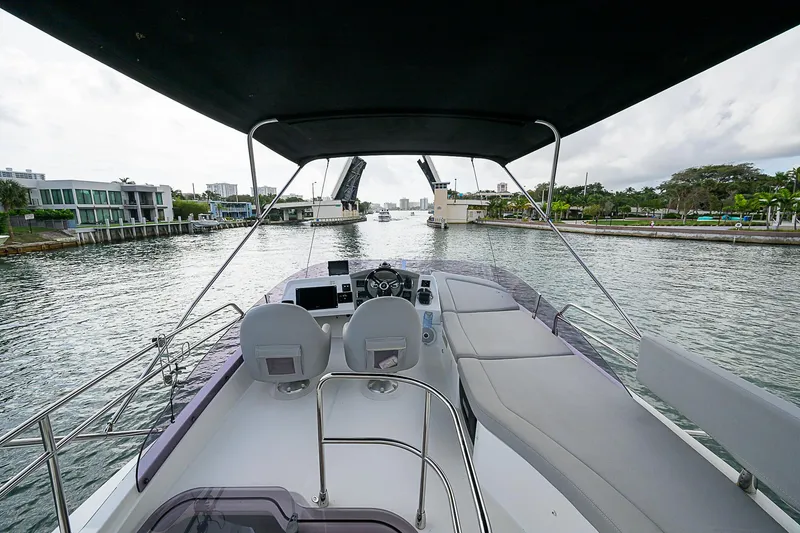 Slide: The Image of 2017 Beneteau Gran Turismo 49 Fly yacht, spacious deck view, cruising through a scenic waterway. - 30