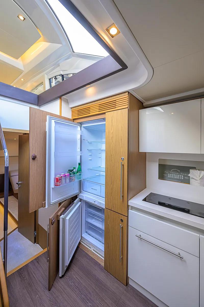 Slide: The Image of 2017 Beneteau Gran Turismo 49 Fly yacht kitchen with open fridge and modern cabinetry. - 44