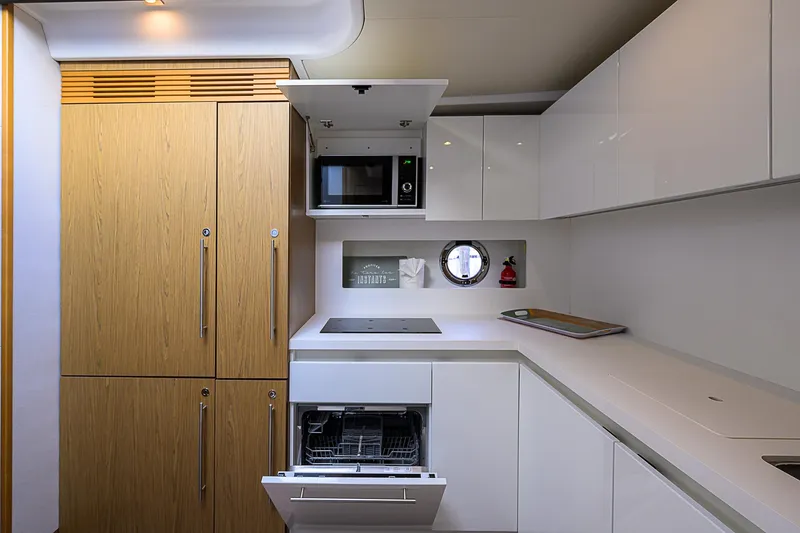 Slide: The Image of Modern kitchen in 2017 Beneteau Gran Turismo 49 Fly yacht with sleek cabinetry and appliances. - 48