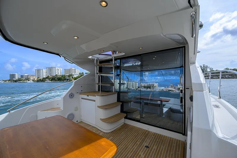 Slide: The Image of 2017 Beneteau Gran Turismo 49 Fly yacht with spacious deck and scenic waterfront view. - 5