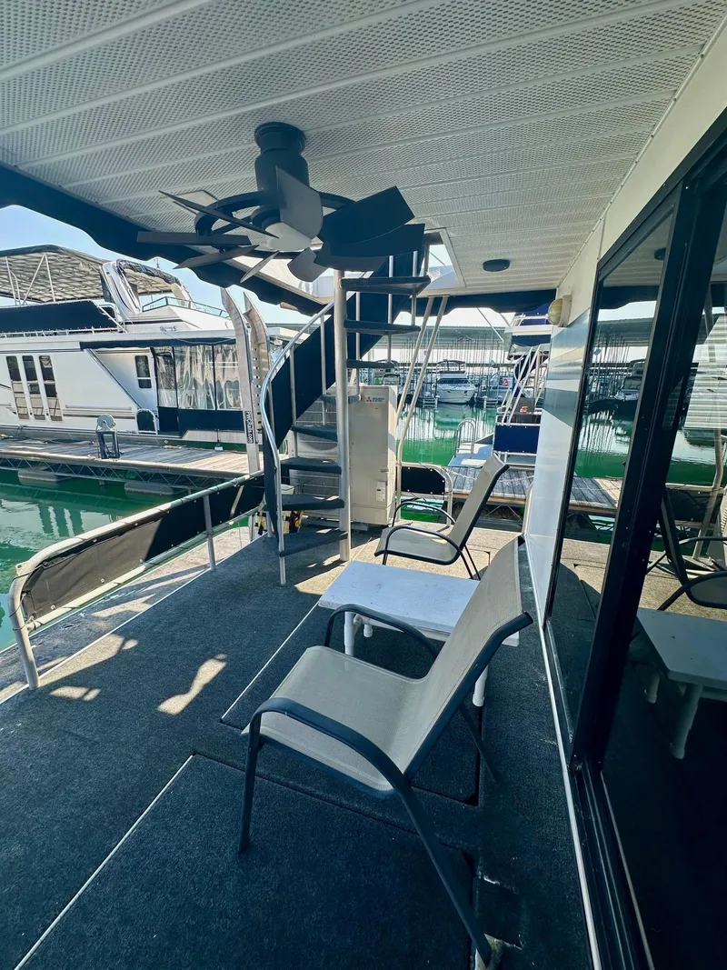 Slide: The Image of Houseboat deck with chairs, ceiling fan, and spiral staircase, Lakeview 15x70, 1995 model. - 13