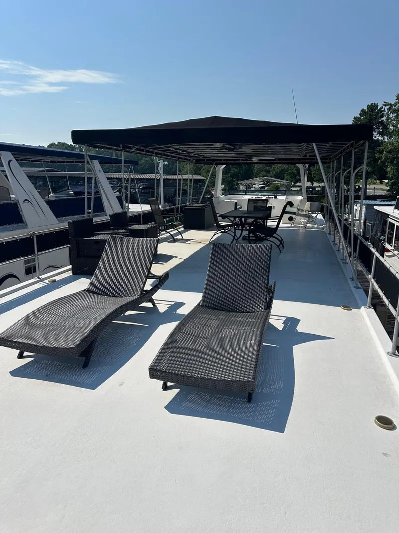 Slide: The Image of Upper deck of 1995 Lakeview 15x70 houseboat with lounge chairs and canopy. - 14