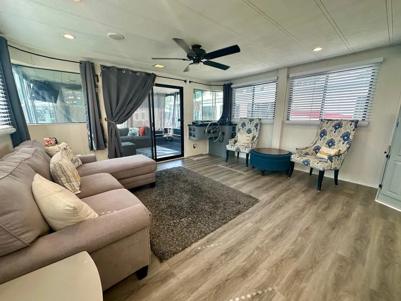 Slide: The Image of Spacious Lakeview 15x70 houseboat interior with modern decor, featuring a cozy seating area. - 3