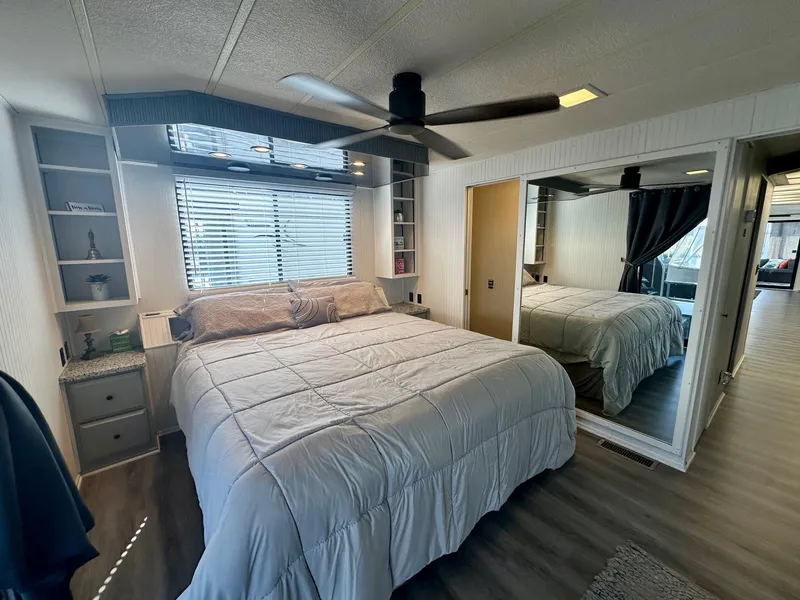 Slide: The Image of Cozy bedroom in 1995 Lakeview 15x70 houseboat with mirrored closet and ceiling fan. - 9