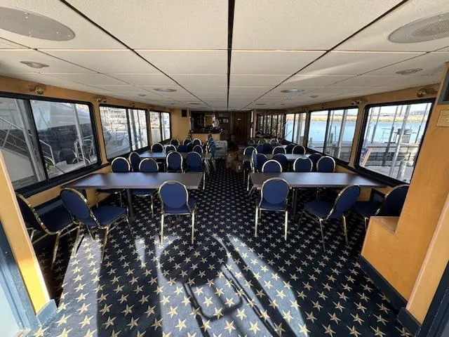 Slide: The Image of 1994 Skipperliner 5800 boat interior with bench seating and outdoor view. - 16