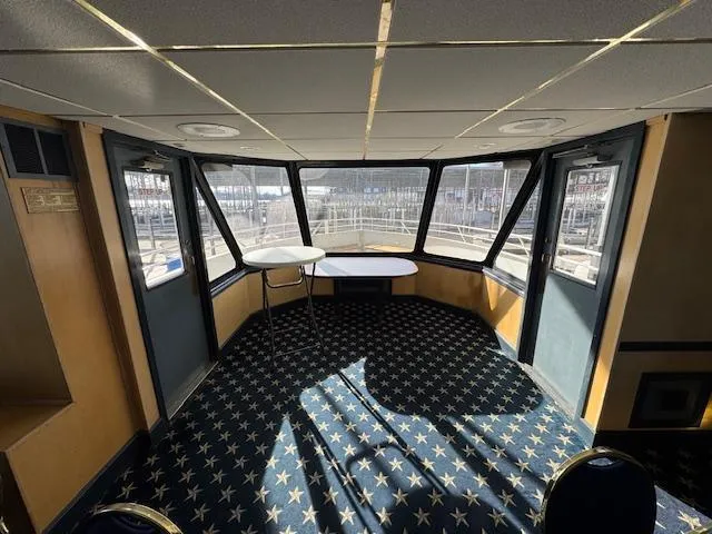 Slide: The Image of Interior of 1994 Skipperliner 5800 with blue chairs and star-patterned carpet. - 17