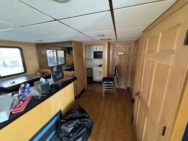 Slide: The Image of Interior of 1994 Skipperliner 5800 with blue chairs and tables, star-patterned carpet. - 20