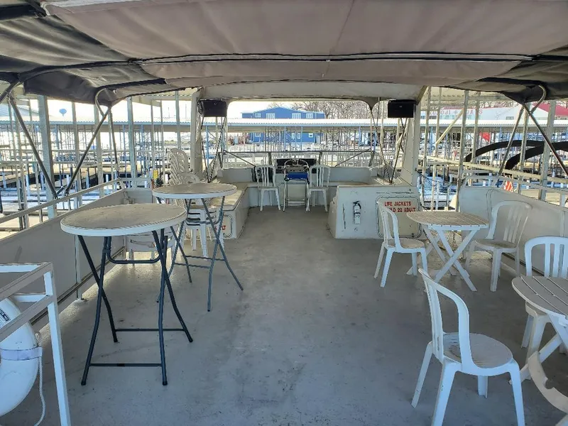 Slide: The Image of 1994 Skipperliner 5800 docked with other boats under a covered marina. - 4