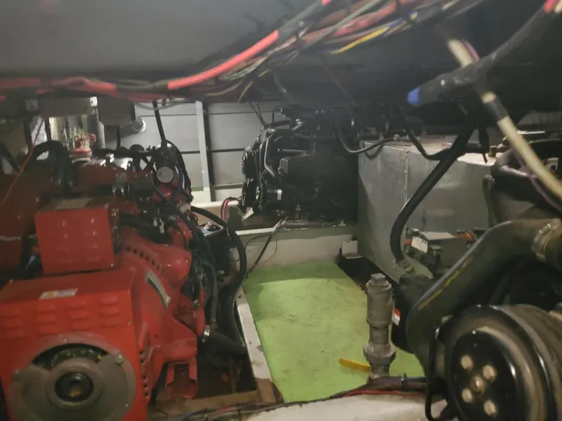 Slide: The Image of Engine room of a 1994 Skipperliner 5800 with visible red machinery and wiring. - 8