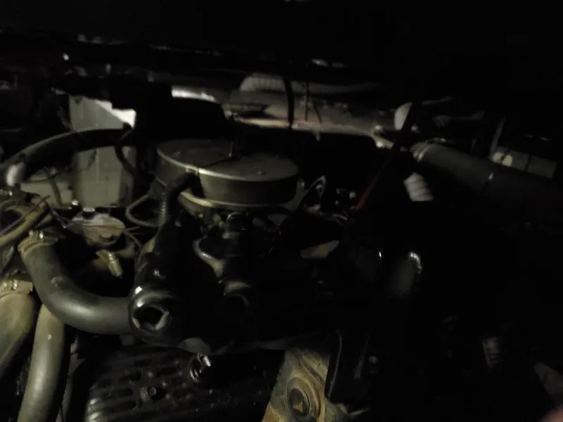 Slide: The Image of Engine components of a 1994 Skipperliner 5800, featuring hoses and metal parts. - 9