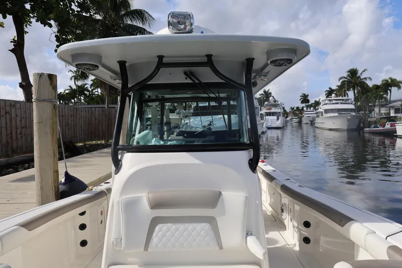 Slide: The Image of 2020 World Cat 325 CC boat docked in a marina with palm trees. - 13