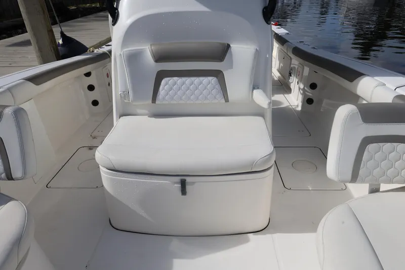 Slide: The Image of 2020 World Cat 325 CC boat interior with cushioned seating and storage. - 14