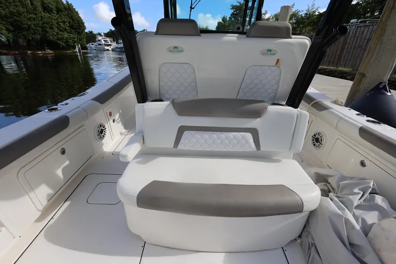 Slide: The Image of 2020 World Cat 325 CC boat interior with cushioned seating and storage compartments. - 18