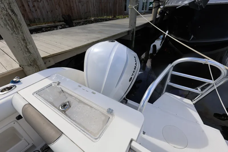 Slide: The Image of 2020 World Cat 325 CC boat with Yamaha engine docked by wooden pier. - 19