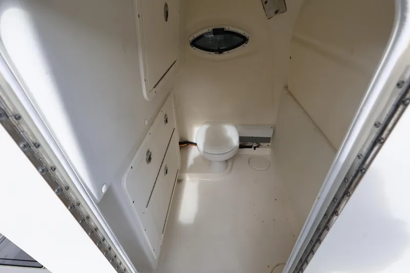 Slide: The Image of Interior of 2020 World Cat 325 CC boat bathroom with toilet and storage cabinets. - 24