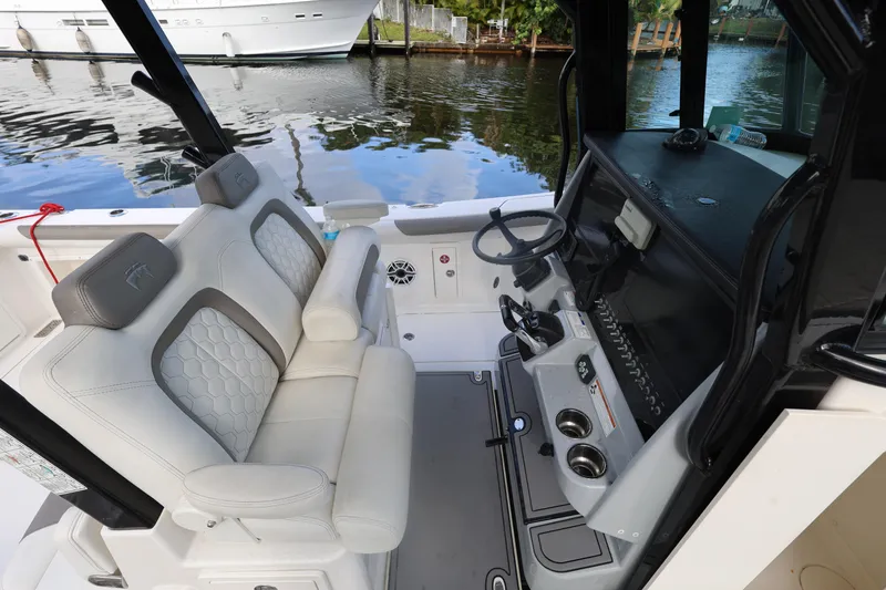 Slide: The Image of 2020 World Cat 325 CC boat interior with dual seats and steering console. - 25