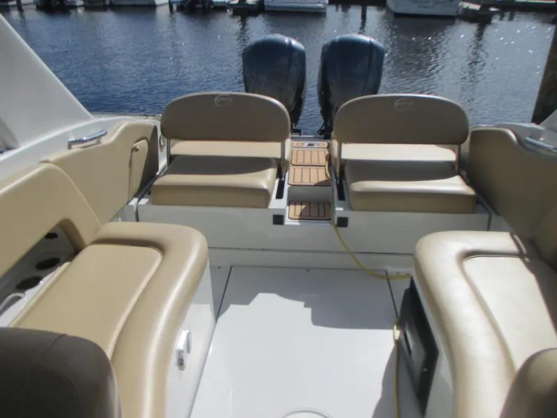 Slide: The Image of 2018 Crownline Eclipse E29 XS boat interior with tan seating and dual engines. - 11