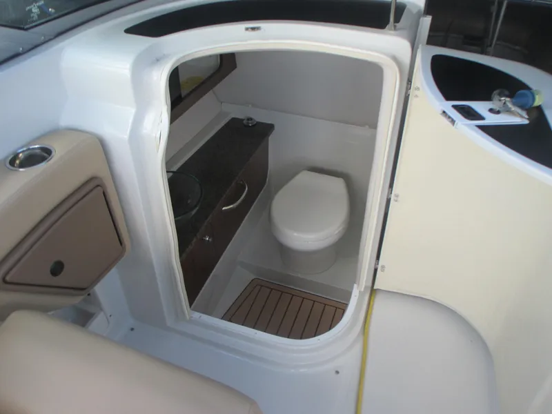 Slide: The Image of 2018 Crownline Eclipse E29 XS boat interior bathroom with toilet and sink. - 22