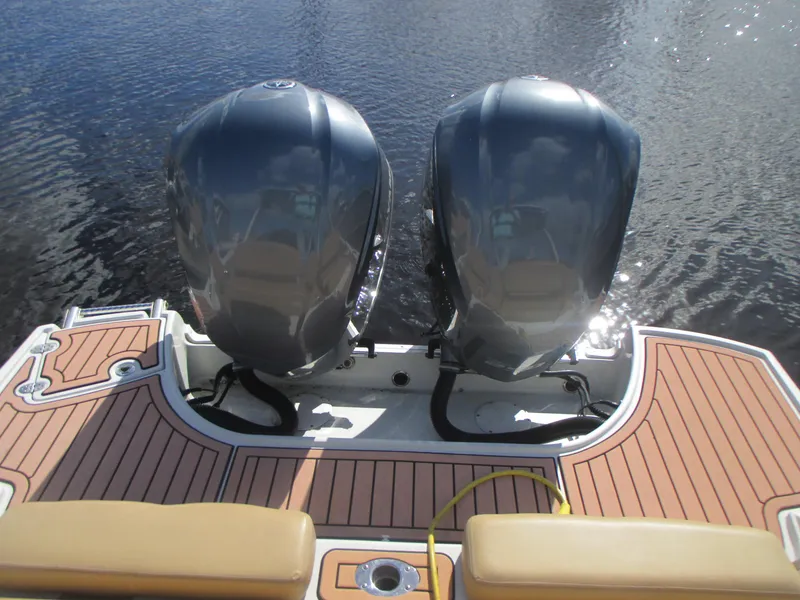 Slide: The Image of 2018 Crownline Eclipse E29 XS boat with dual outboard motors on teak deck. - 5