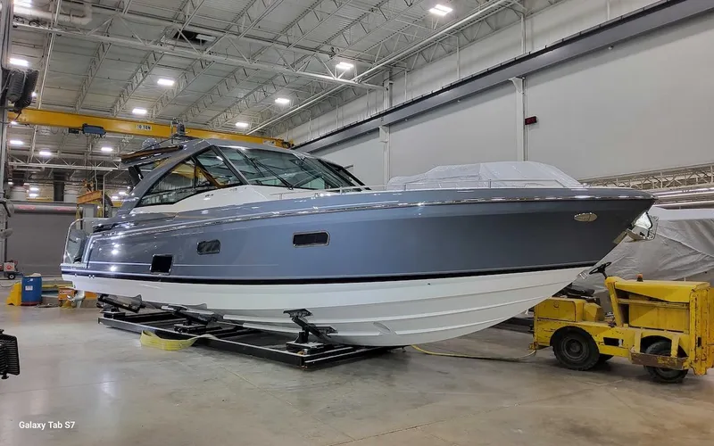 Slide: The Image of 2024 Formula 430 Super Sport Crossover boat in a spacious indoor facility. - 10