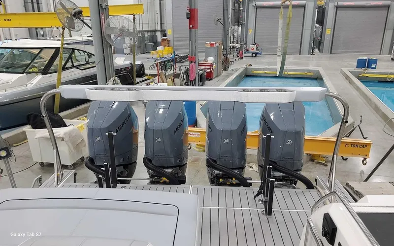 Slide: The Image of 2024 Formula 430 Super Sport Crossover with four outboard engines in a workshop setting. - 11