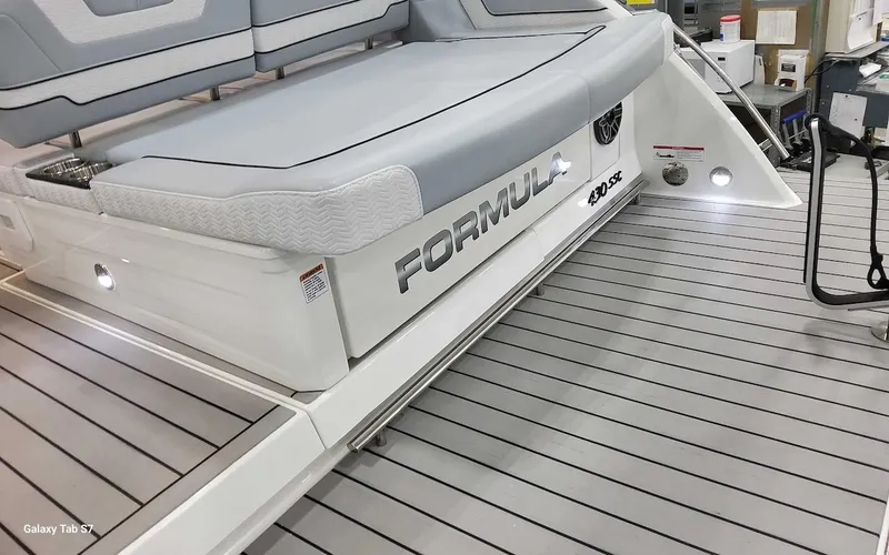 Slide: The Image of 2024 Formula 430 Super Sport Crossover boat deck with seating and logo. - 14