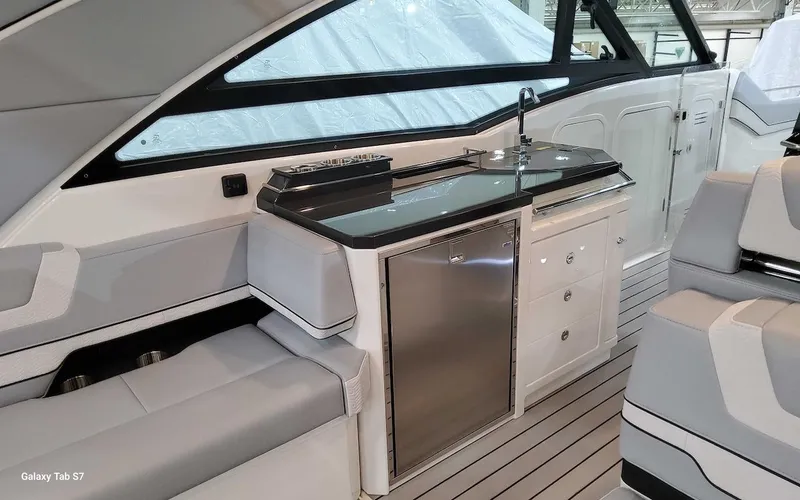 Slide: The Image of 2024 Formula 430 Super Sport Crossover interior with sleek kitchenette and seating area. - 21