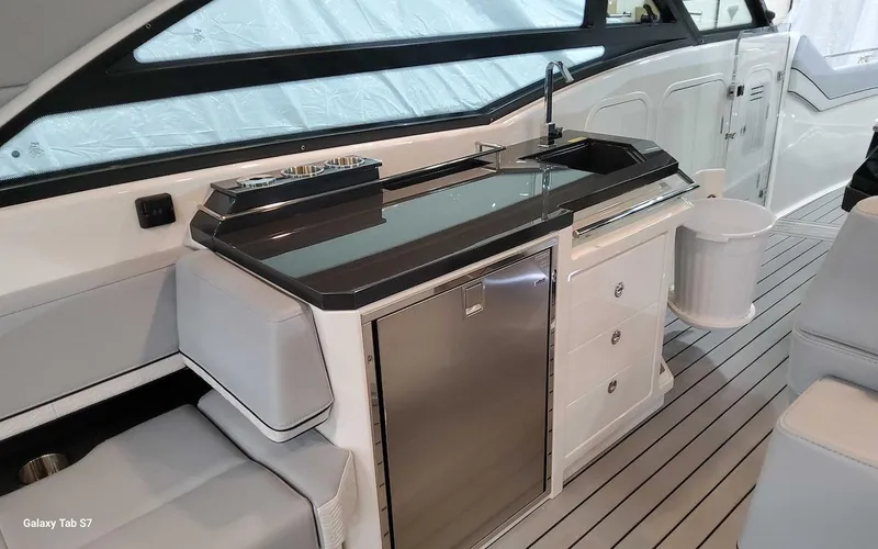 Slide: The Image of 2024 Formula 430 Super Sport Crossover yacht interior with sleek kitchenette and modern design. - 22