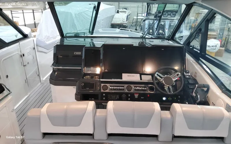 Slide: The Image of 2024 Formula 430 Super Sport Crossover boat cockpit with modern controls and seating. - 25