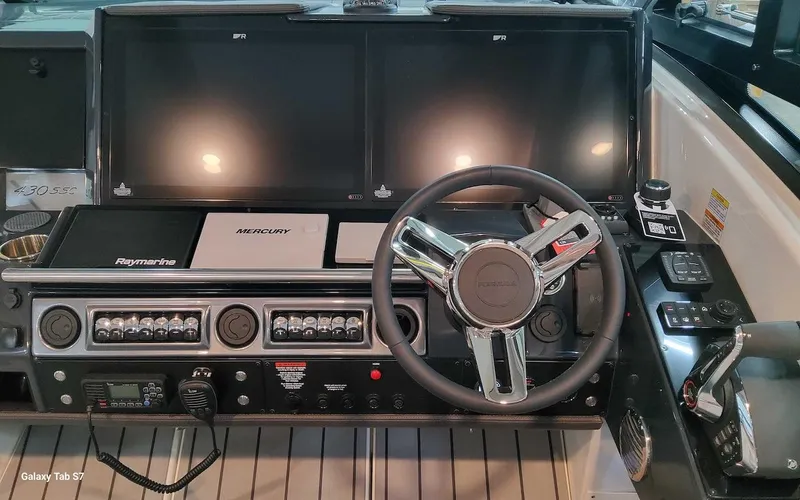 Slide: The Image of 2024 Formula 430 Super Sport Crossover dashboard with dual screens and modern controls. - 26