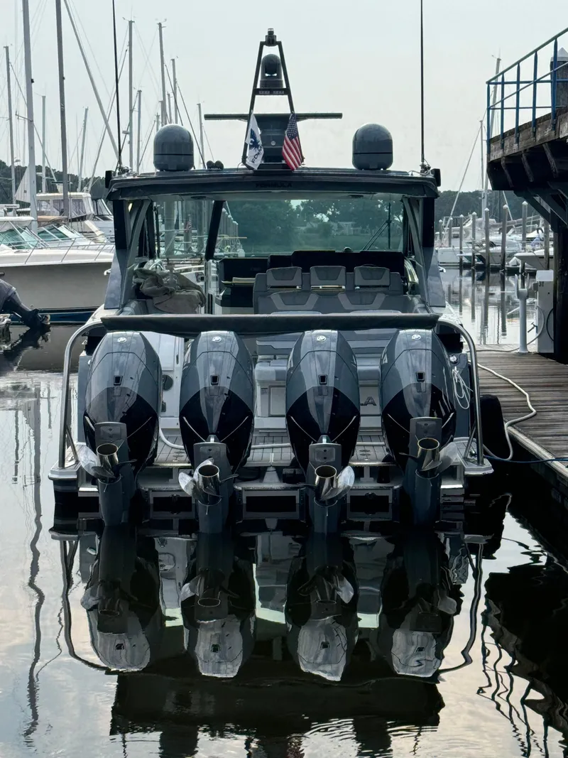 Slide: The Image of 2024 Formula 430 Super Sport Crossover boat docked with four powerful engines. - 3