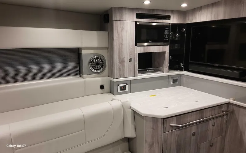 Slide: The Image of 2024 Formula 430 Super Sport Crossover interior with modern kitchen and seating area. - 35