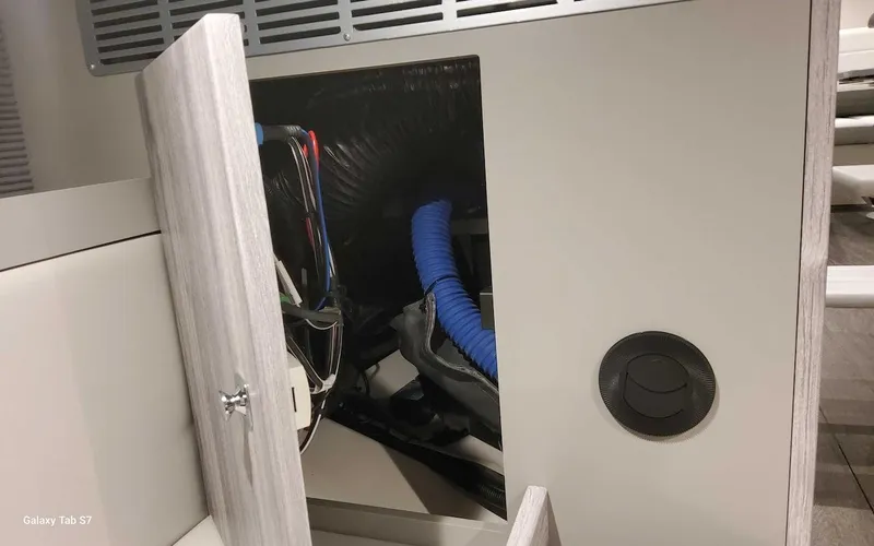 Slide: The Image of Open compartment in 2024 Formula 430 Super Sport Crossover, showing interior wiring and components. - 40