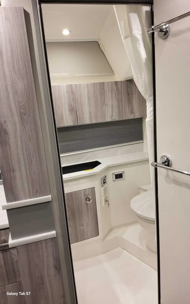 Slide: The Image of 2024 Formula 430 Super Sport Crossover bathroom interior with modern design and wood accents. - 41