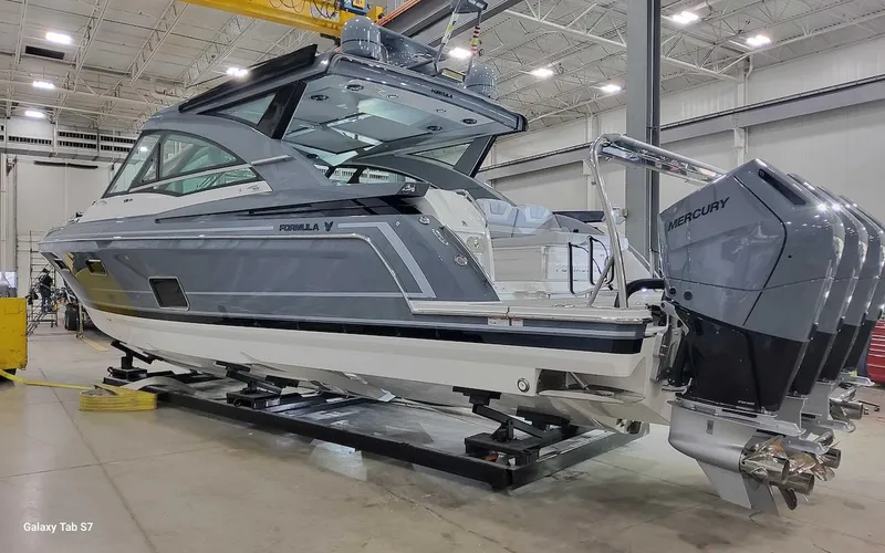 Slide: The Image of 2024 Formula 430 Super Sport Crossover boat with Mercury engines in a showroom. - 6