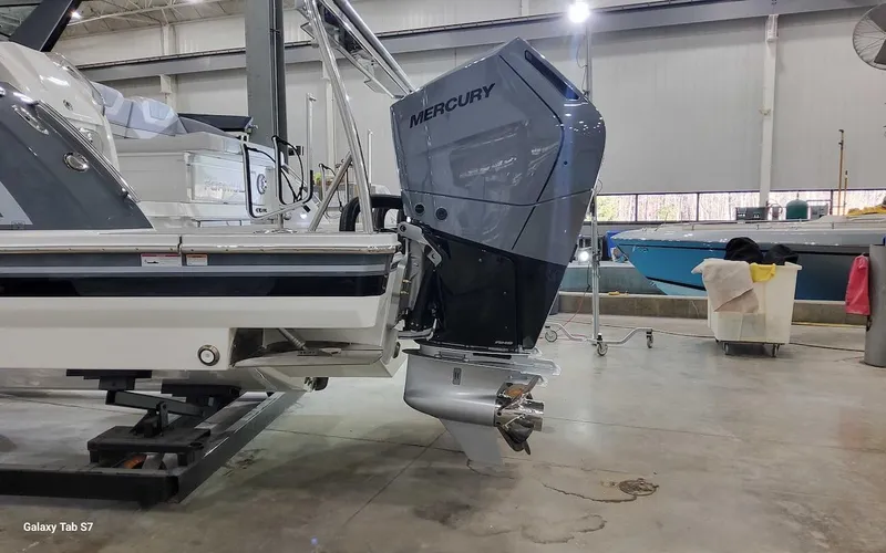 Slide: The Image of 2024 Formula 430 Super Sport Crossover with Mercury outboard engine in a showroom. - 8