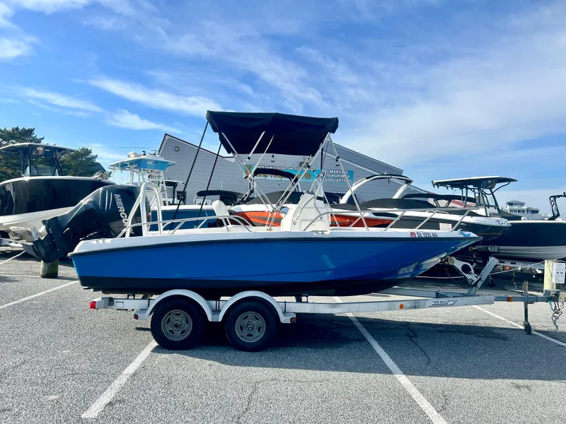 Slide: The Image of 2011 Boston Whaler DAUNTLESS 180/CC boat on trailer in parking lot. - 0