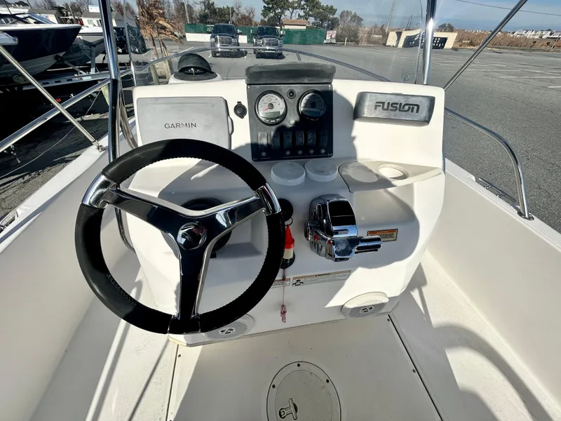 Slide: The Image of 2011 Boston Whaler Dauntless 180/CC boat console with steering wheel and controls. - 11