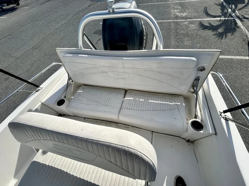 Slide: The Image of 2011 Boston Whaler DAUNTLESS 180/CC boat interior with white seating and cup holders. - 13